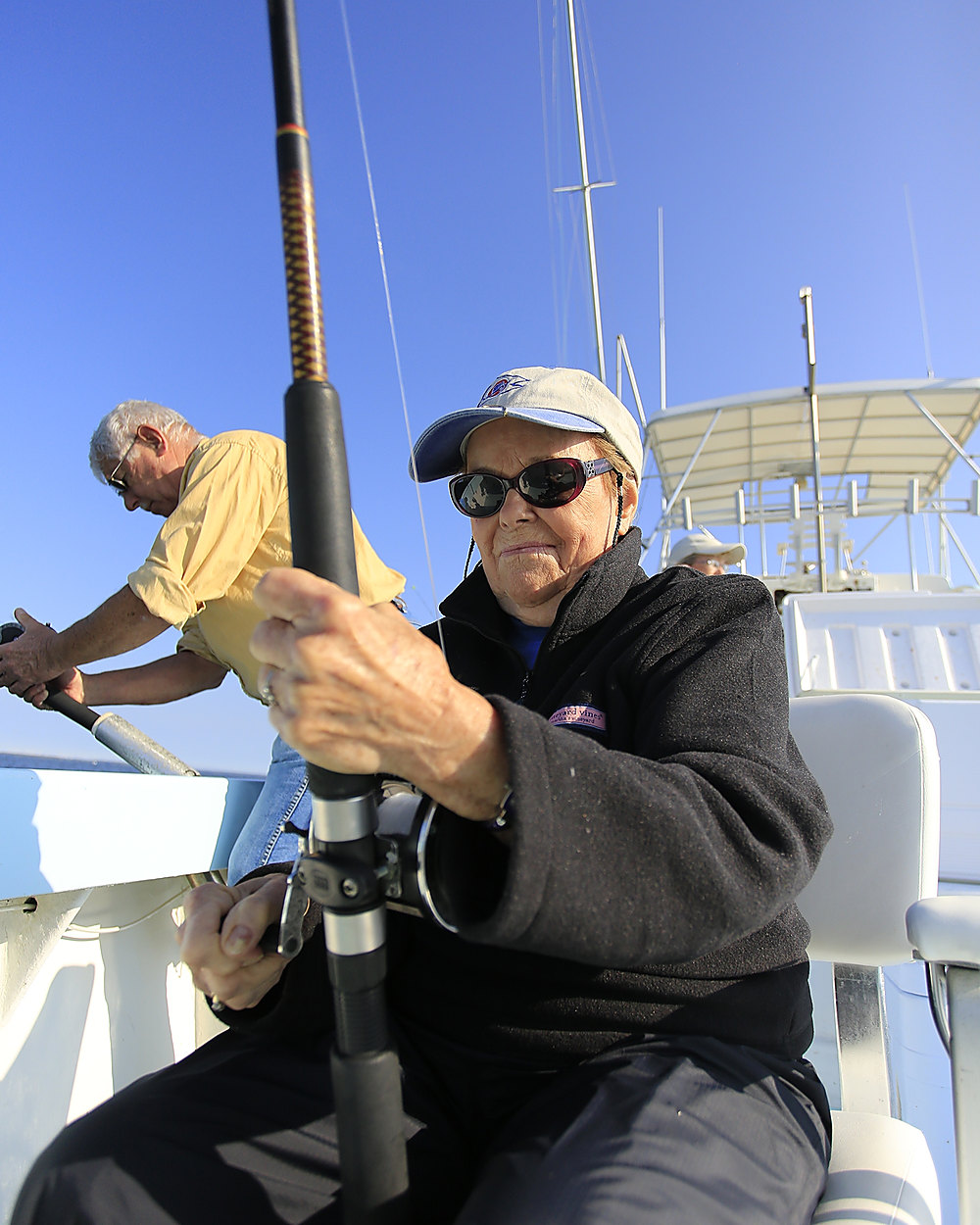 An angler in the fighting chair working a heavy rod on Class Act