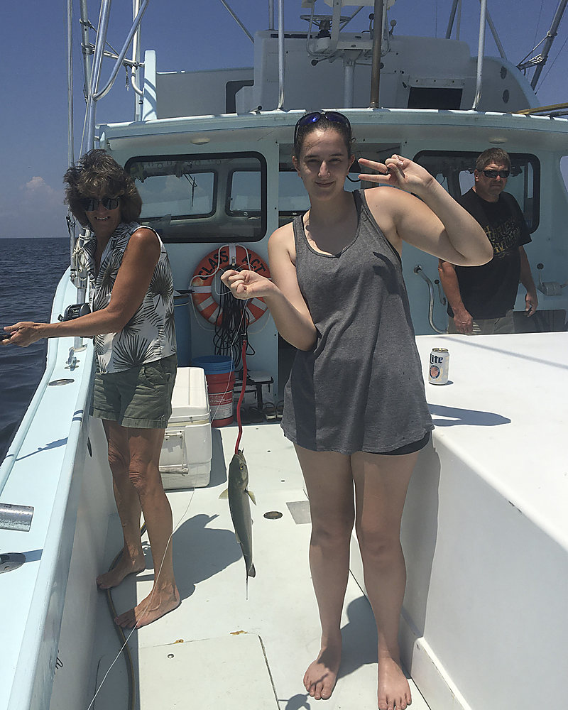 A young angler with her catch on the deck