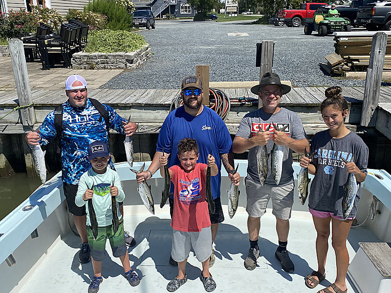 A family group of eight on the Class Act deck with their catch