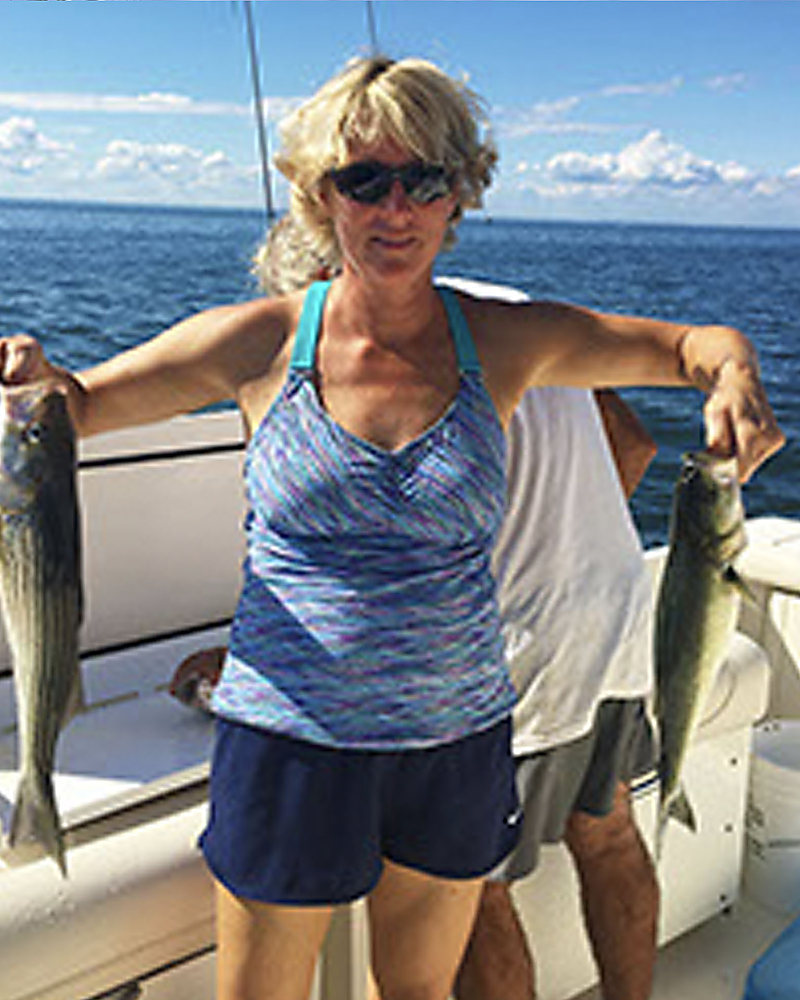 An angler holding up a rockfish in each hand