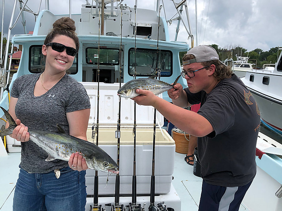 Two anglers on the deck with their fish